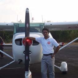Student checking engine oil pre-flight check at airport
